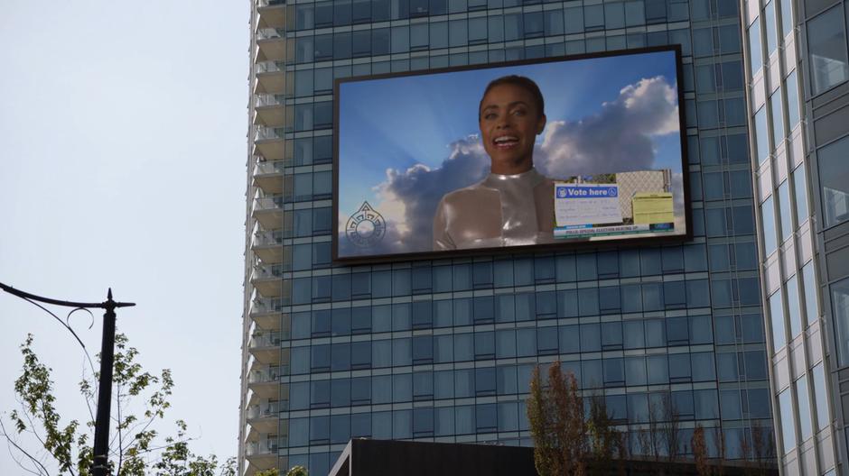 An Obsidian advertisement appears on the jumbotron shrinking down the news report on the election.