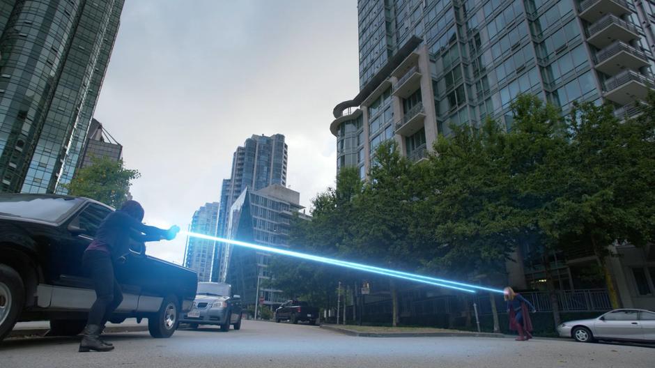 Malefic in Alex's form redirects Kara's heat vision back at her with a side mirror from a car.