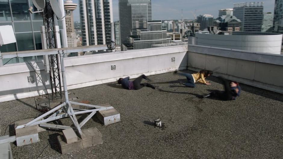 Malefic, still in the form of Alex, crashes into to rooftop and knocks Alex and Kelly to the ground.