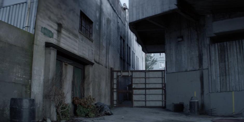 Establishing shot of the alley leading to Mary's clinic.