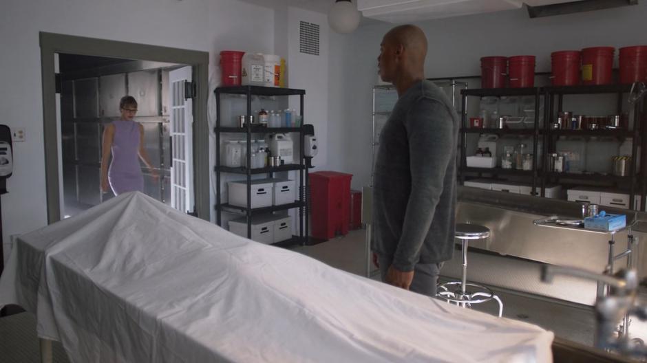 Kara enters the morgue to where James is waiting over the covered body of Dr. Jarrod.