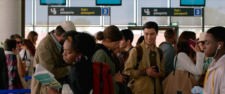 Brad laughs while talking to Michelle after the flight.