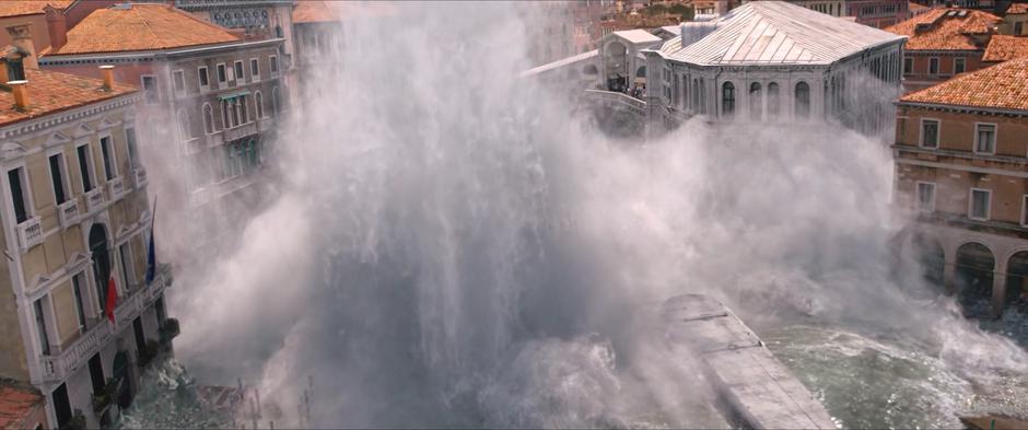 A giant plume of water sprays up near the bridge as the elemental emerges.