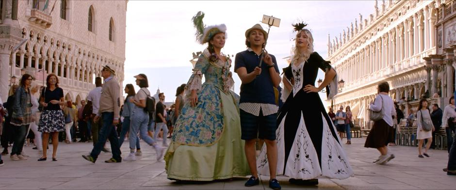 Flash records a video using a selfie-stick with two women in period costumes.