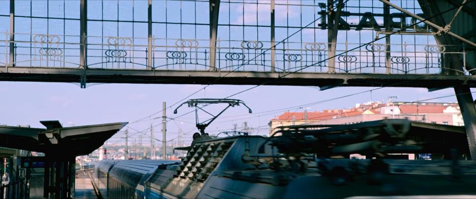 Peter kneels down on top of the trian as it leaves the station.