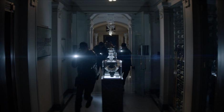 Crows rush through the museum with flashlights after the power goes out.