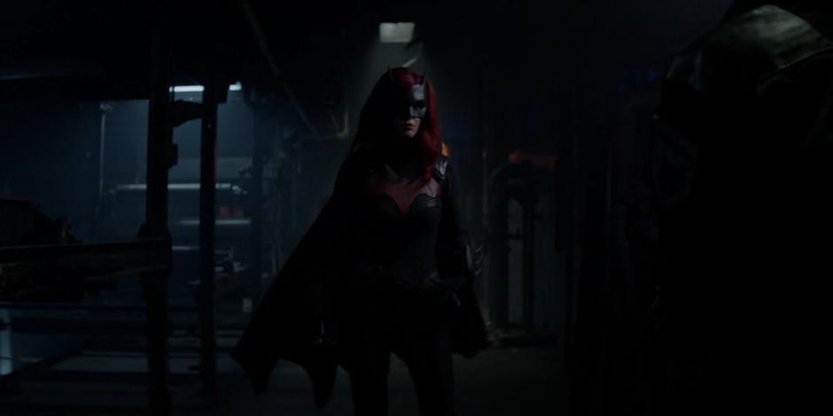 Kate as Batwoman turns around when she hears Sophie approaching.