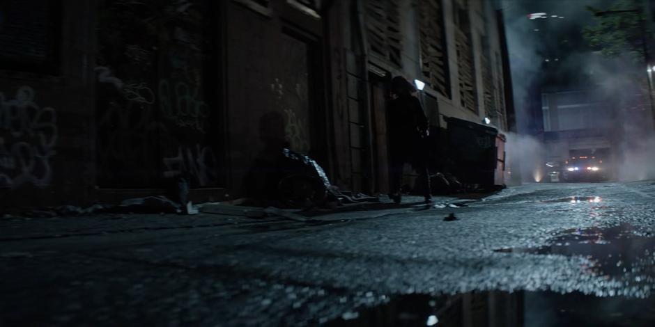 Kate walks out of the sniper's nest and walks down the alley away from the flashing lights on the Crows trucks.