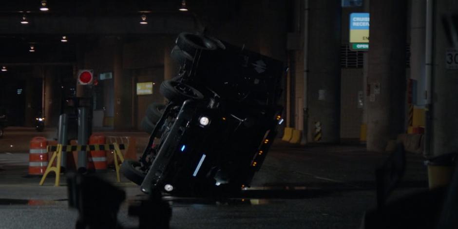 The Crows truck flips over after losing control as Kate approaches from the distance.