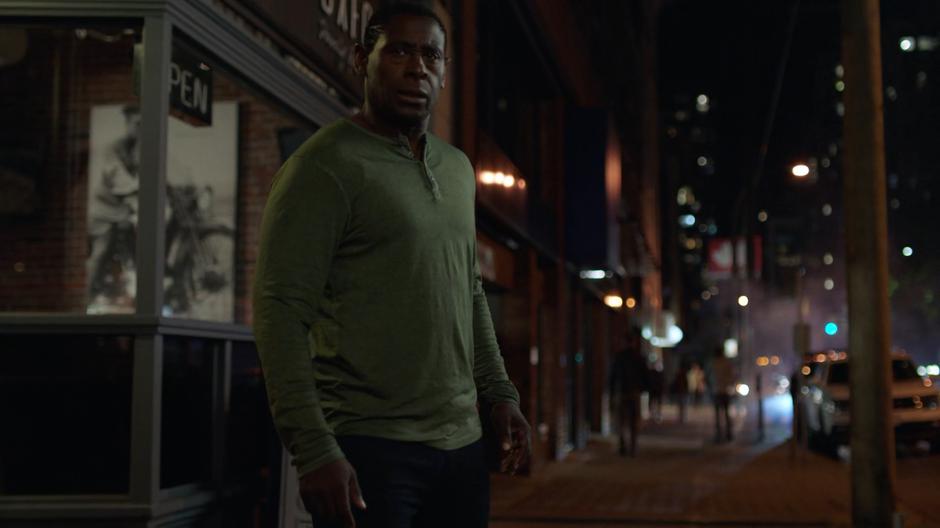 J'onn stops in the street when he feels his brother's psychic powers.