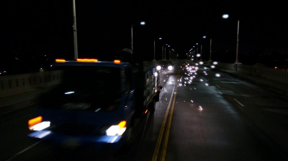 Sparks fly from the truck as Alex and Hank shoot at it from their vehicle behind.