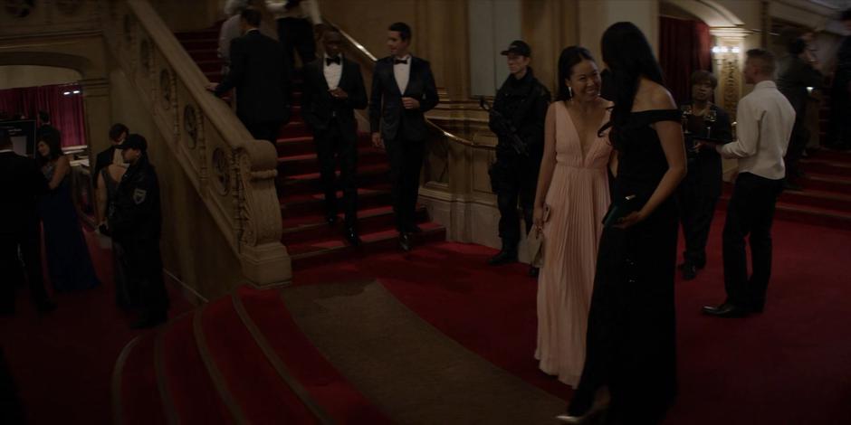 Mary and Catherine smile at one another in the lobby before the gala.