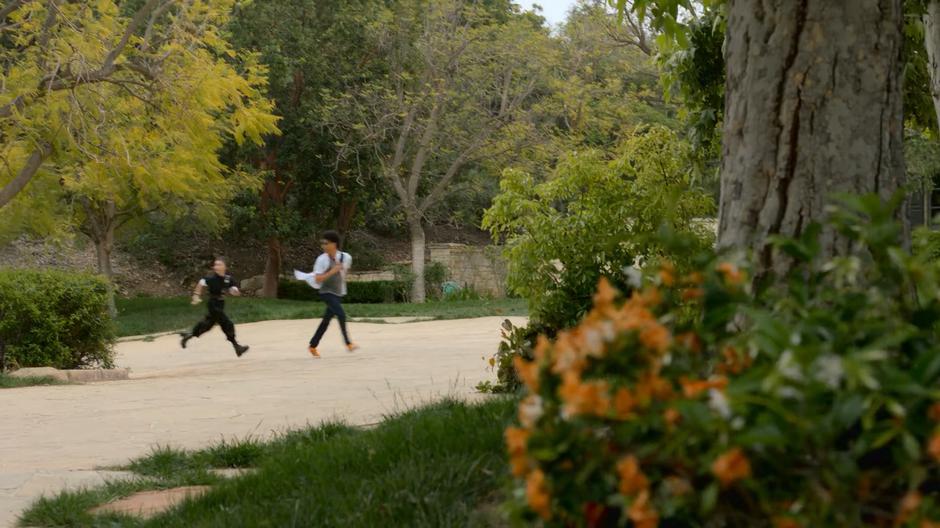 Nico and Alex look over their shoulders as their run across the drive towards the house.