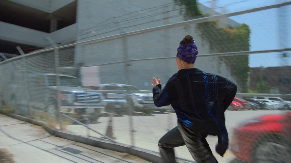 Magistrate races down the alley past a fence.