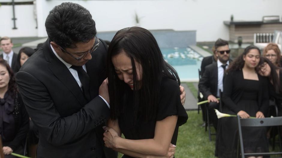 Robert hugs a devastated Nico after she has prayed over Amy's picture.