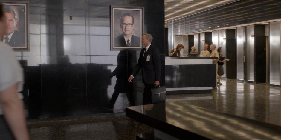 Von Braun looks at the spot on the lobby wall where his portrait used to hang as he leaves.