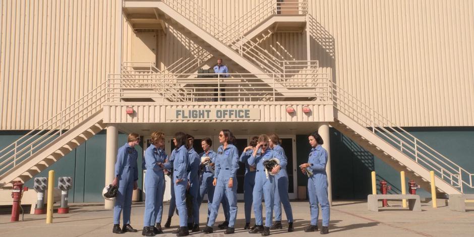 The ASCANs chat while standing in a group in front of the flight office.