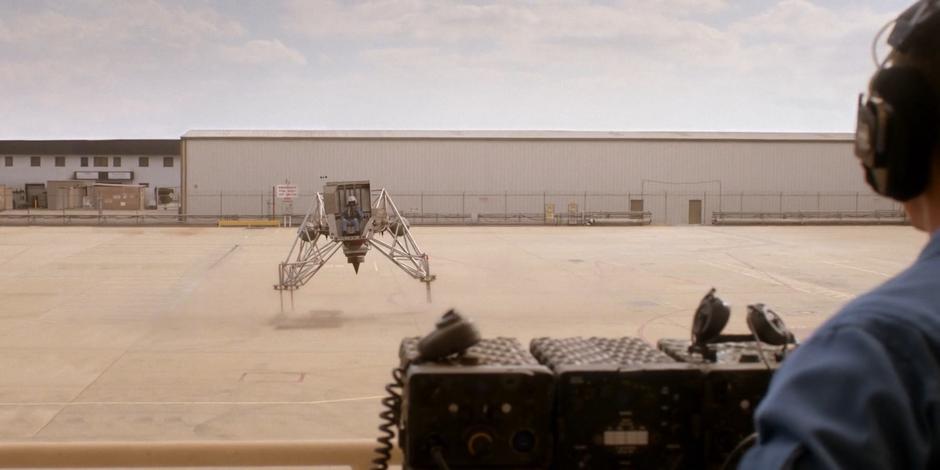 Ed watches from the control area while Tracy lifts off in the LLTV.