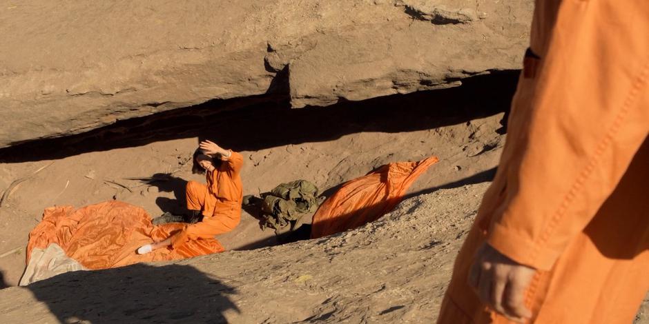 Ellen shields her eyes to look up at Tracy from where she fell.