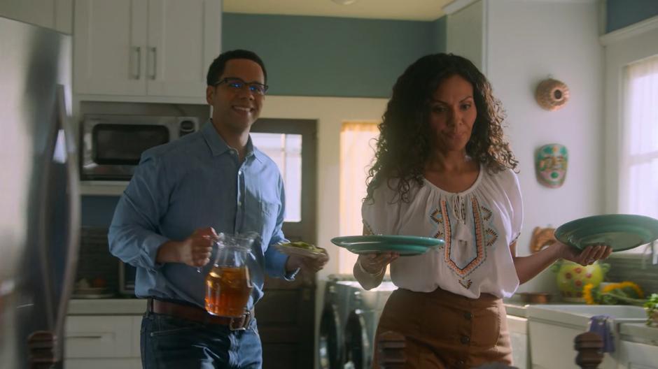 Gene and Alice Hernandez smiles at Molly as they set the table.