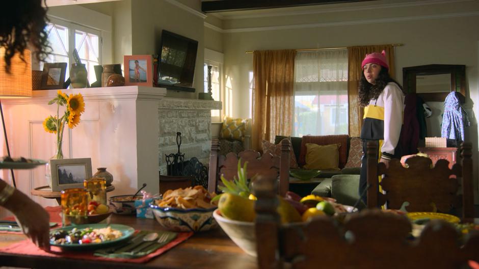 Molly turns and sees her parents standing over the dining table.