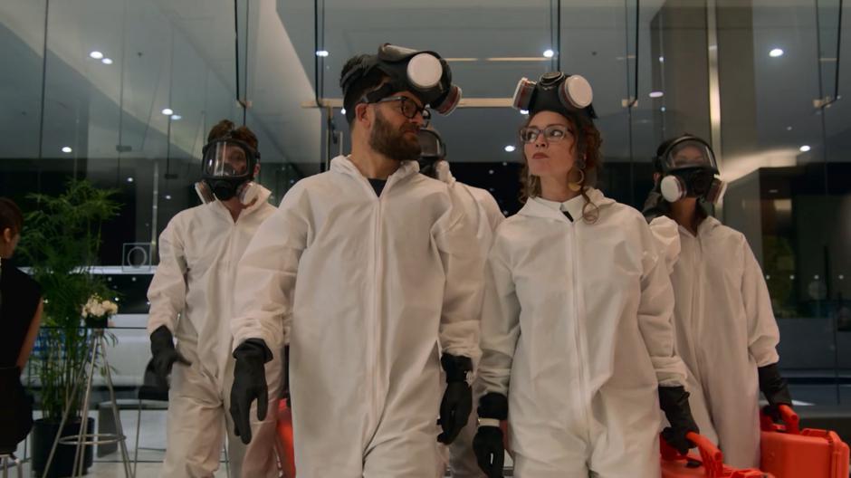 Dale and Stacey share a look while entering the lobby with Victor, Geoffrey, and Tina disguised as CDC employees.