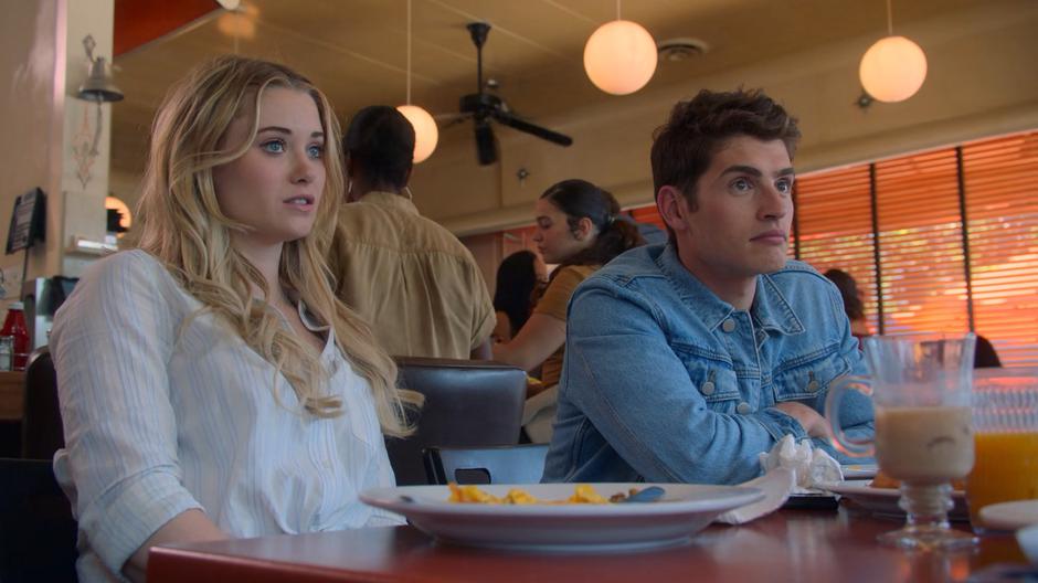 Karolina and Chase sit at the table after finishing brunch and chat with Gert and Molly.