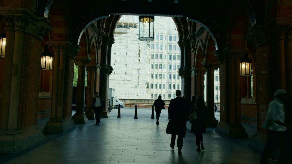 Conrad and Monica talk as they walk out of the station.