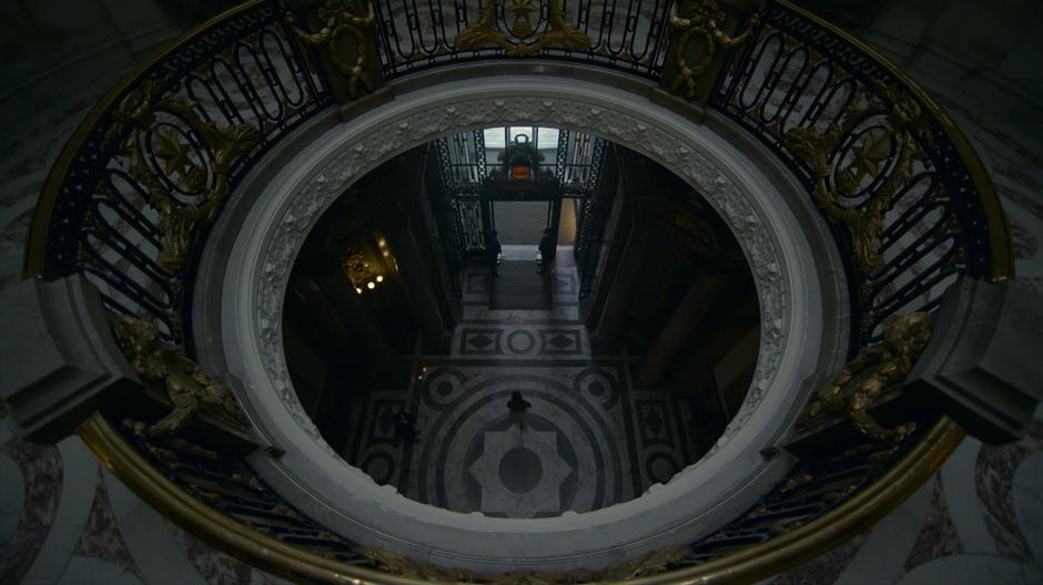 Myfanwy walks across the lobby towards the exit.