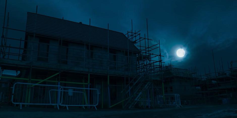 Nighttime establishing shot of the house the three of them are hiding within.