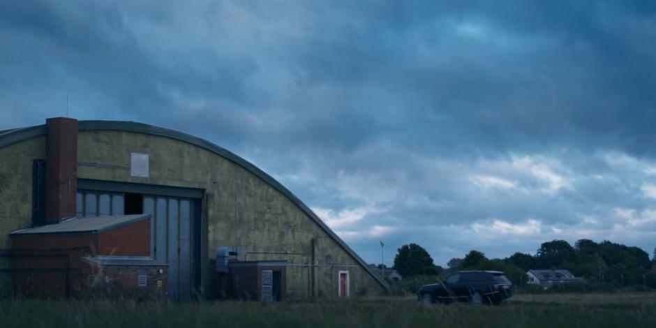 Yaz, Ryan, and Graham stop their stolen car outside the hanger.