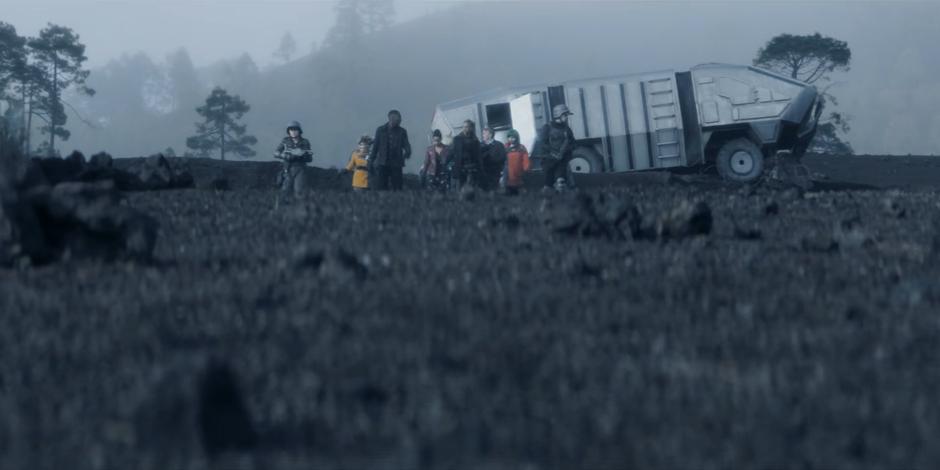 The group emerges from the crashed truck and drives across the landscape.