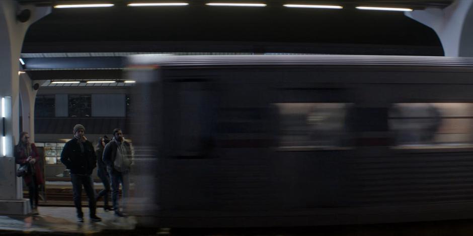 The train races through the station without stopping.