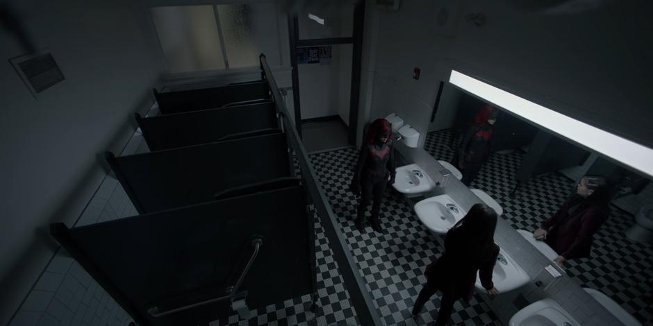 Kate confronts Parker in the school bathroom.