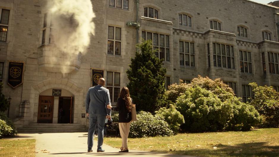 Dean Fogg and Julia look up at the classroom above them explodes after another surge.