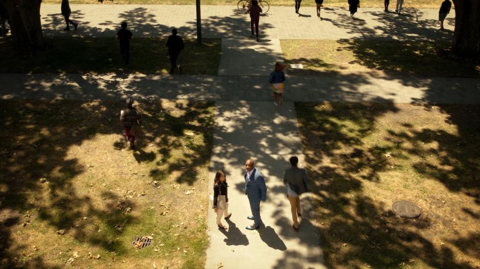 Julia and Dean Fogg stand on the sidewalk as people run out of the building after the explosion.