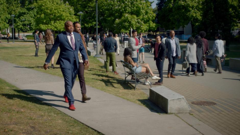 Dean Fogg walks with Penny down the path through the now very crowded campus.