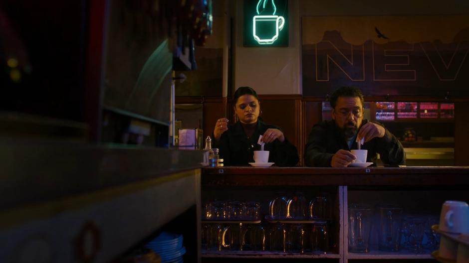 Mel and Ray pour sugar into their coffees in identical fashions.