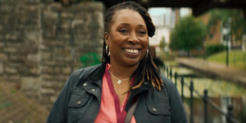 Ruth smiles at some folks as she walks along the canal.