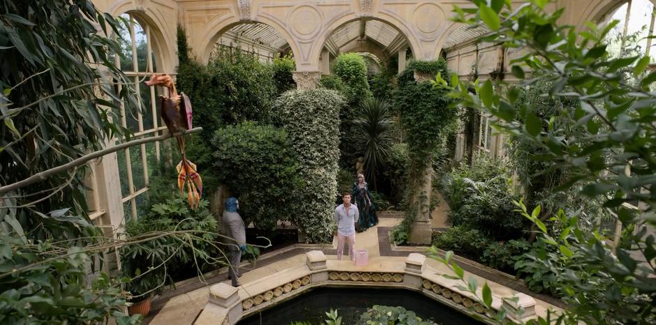 Luca keeps an eye on H while Riza emerges from deeper in the greenhouse.