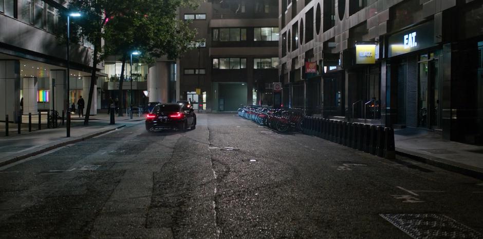 H speeds down the street after leaving skid-marks on the pavement.