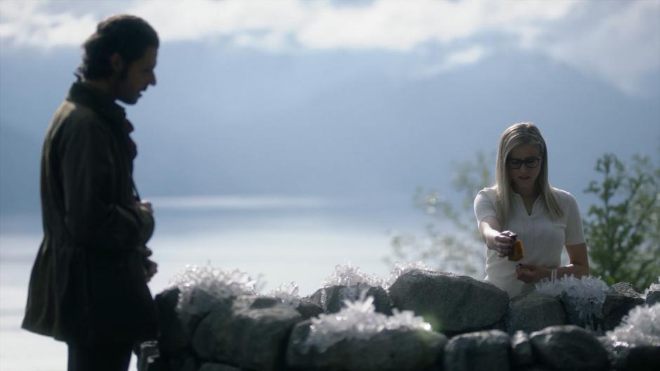 Eliot watches as Alice prepares to drop Quentin's Essence into the well.