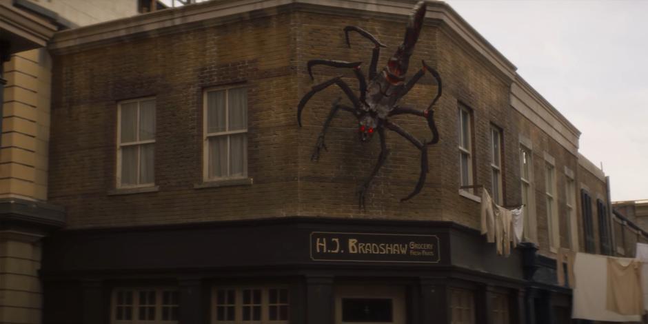 One of the Skithra climbs on the side of a building.