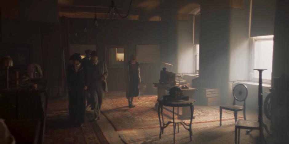 Yaz, Ryan, Graham, and the Doctor look around Tesla's rather empty lab.