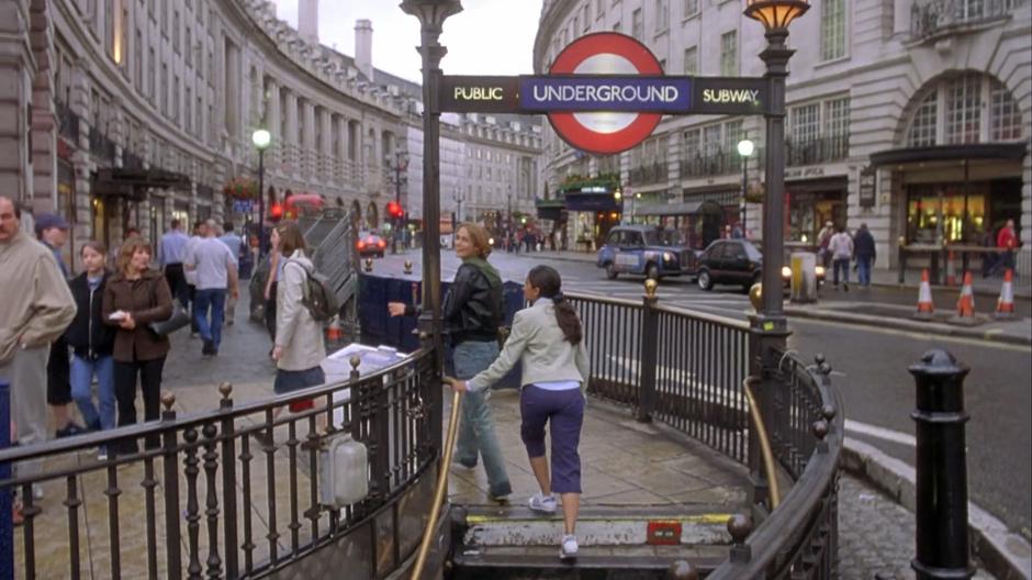 Jules and Jess look around while exiting the Underground station.