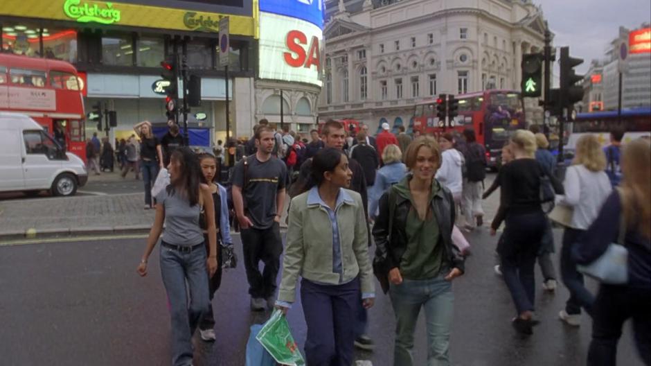 Jess and Jules chat while crossing the street back to the station with their shopping.