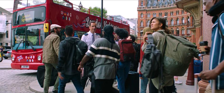 MJ looks around as one Quentin Beck's conspirators greats the students posed as a bus tour guide.