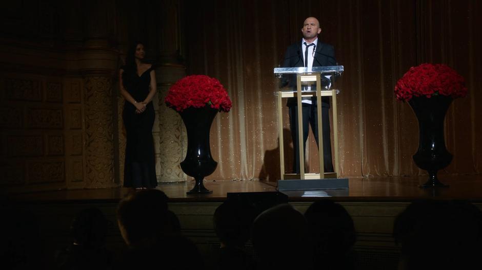 Mick annonces a winner onstage during the Academy Awards.