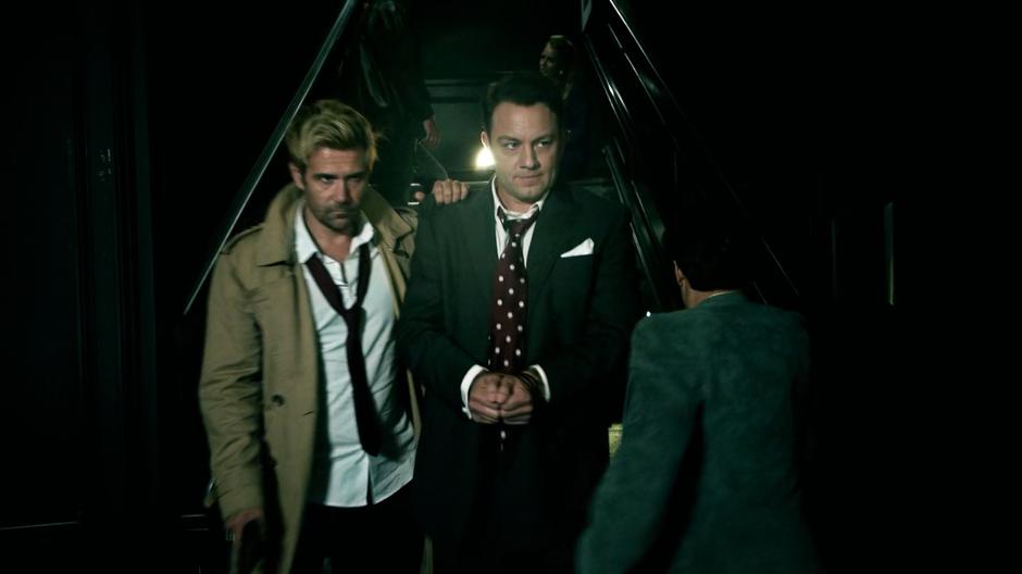 Constantine escorts Bugsy down the stairs into the club.