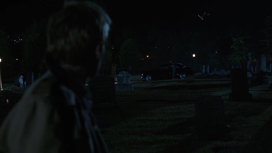 Constantine turns and sees Jeanie Hill entering her car.